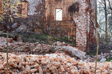 Collapsed outer wall of an old abandoned brick house. Belkino Estate, Russia