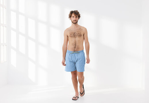 Mockup of man wearing customizable patterned shorts and no top