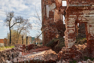 Collapsed outer wall of an old abandoned brick house. Belkino Estate, Russia