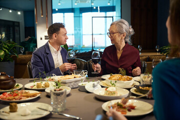 Man and woman holding glasses while toasting, celebrating New Years Eve