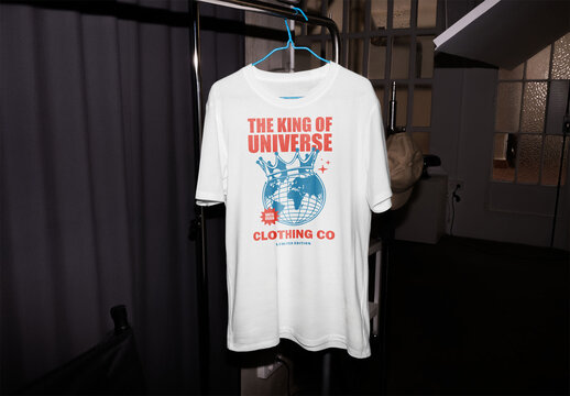 Mockup of customizable t-shirt on clothes rail, camera flash