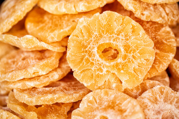 Close up of pineapple slices, dehydrated dried fruit, Food background.