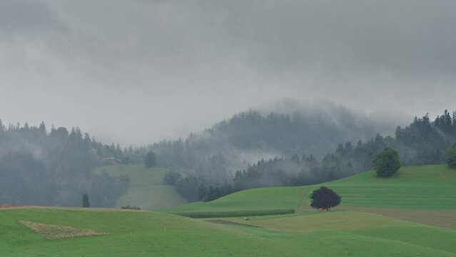Clouds and fog rolling through the hills in the Emmental in Switzerland