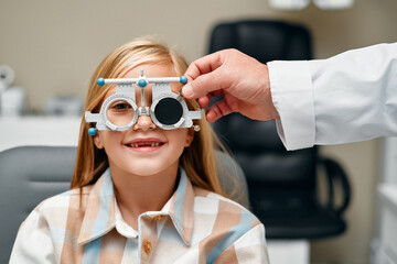 Glasses fitting and eye examination by an ophthalmologist - obrazy, fototapety, plakaty