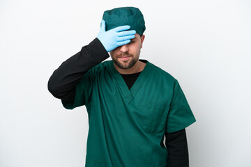 Surgeon in green uniform isolated on white background covering eyes by hands. Do not want to see...