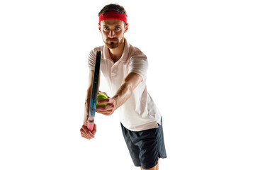 Portrait of man, concentrated tennis player in sportswear standing with tennis racket and ball isolated over white background. Concept of sport, hobby, active and healthy lifestyle, competition