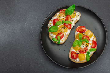 Fresh bread sandwiches with tomato cherry, cream cheese and basil leaves. Morning breakfast concept