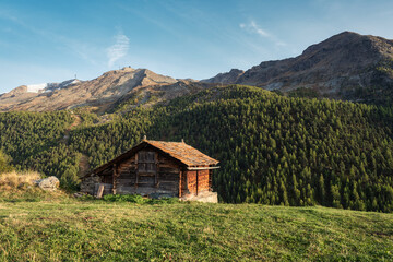 Wooden cottage on hill among the Swiss Alps in mountain village at Zermatt