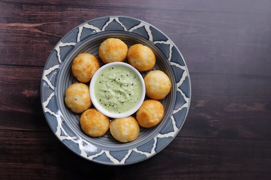 Paniyaram are savory balls made using fermented rice and urad dal batter along with tempered onion and spices. Also known as Paddu, Ponganalu, Kuli, bugga, and appe. served with coconut chutney