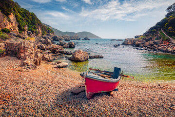Calm spring scene of Limni Beach Glyko with red fishing boat. Stunning morning seascape of Ionian...