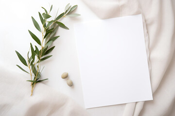 a white sheet of paper with a leaf and some rocks