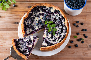 Traditional homemade blueberry pie on wooden table, top view