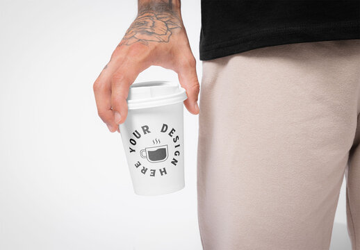 Mockup of man holding takeaway cup with customizable lid and design