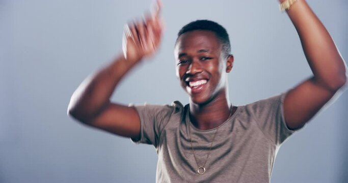 Happy, dance and face of black man on gray background for celebration, good news and excited in studio. Dancer, energy and portrait of isolated person moving to audio, music and song for freedom