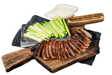Sliced Peking Duck served with cucumber, green onion, and wheaten chinese pancakes on a meat...