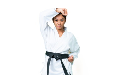 Young Uruguayan woman over isolated chroma key background doing karate
