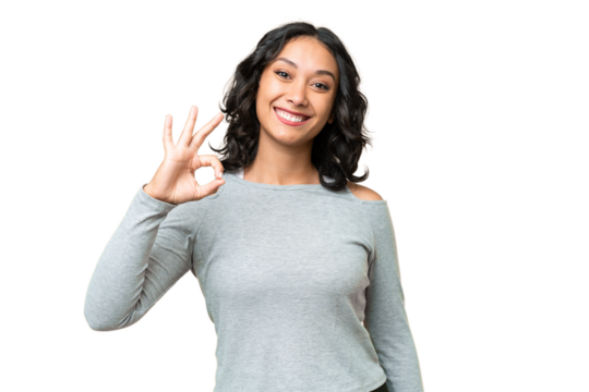 Young Argentinian woman over isolated background showing ok sign with fingers