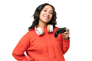 Young Argentinian woman playing with a video game controller over isolated background posing with...