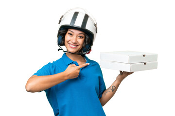 Pizza delivery Argentinian woman with work uniform picking up pizza boxes over isolated background...