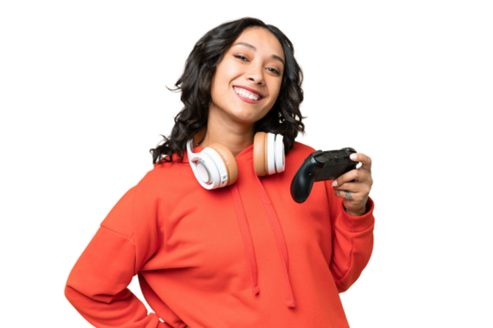 Young Argentinian woman playing with a video game controller over isolated background posing with arms at hip and smiling