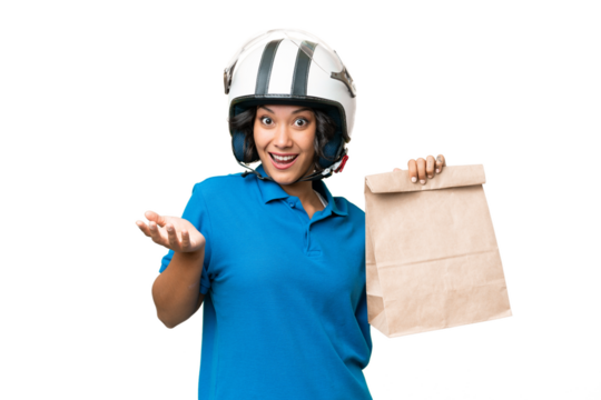 Young Argentinian woman taking a bag of takeaway food over isolated background with shocked facial expression
