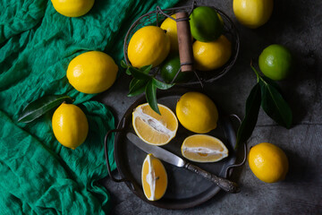 Ripe lemons, limes, calendar for the new year 2024 on a dark background.