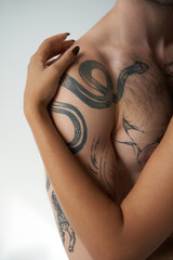 cropped view of african american woman hugging warmly her young tattooed boyfriend, sexy couple