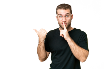 Young handsome blonde man over isolated chroma key background pointing to the side and doing silence gesture