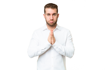 Young handsome blonde man over isolated chroma key background keeps palm together. Person asks for something