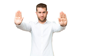 Naklejka premium Young handsome blonde man over isolated chroma key background making stop gesture and disappointed