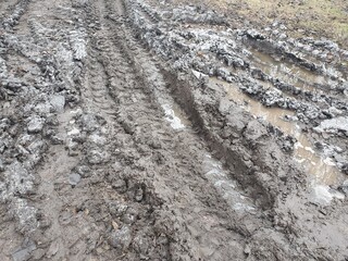Texture of tracks from a bulldozer on the dirt. Tread on mud.