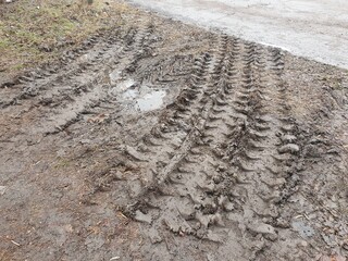Texture of tracks from a bulldozer on the dirt. Tread on mud.
