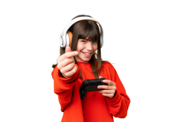 Little caucasian girl playing with a video game controller over isolated background making money gesture