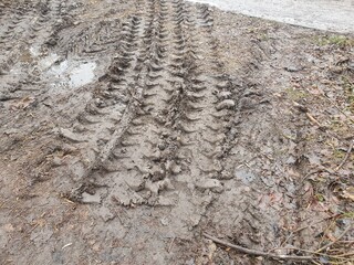 Texture of tracks from a bulldozer on the dirt. Tread on mud.