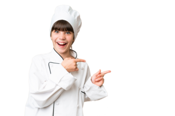 Little caucasian chef girl over isolated background surprised and pointing side