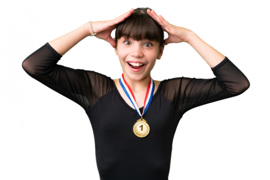 Little caucasian girl with medals over isolated background with surprise expression