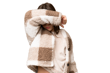 Little girl over isolated green chroma key background covering eyes by hands