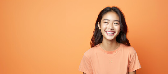 Obraz premium A pretty Asian woman, blending Malaysian and American features, showcases trendy fashion in a cheerful portrait with a yellow sweater.