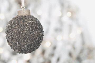 Christmas tree ball ornaments with lights in the background with white space for text.
