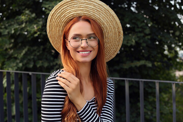 Portrait of beautiful woman in glasses outdoors