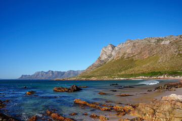 Fototapeta na wymiar View of the gorgeous Rooi Els beach with the Kogelberg Mountains and Clarence Drive in the background. Western Cape. South Africa