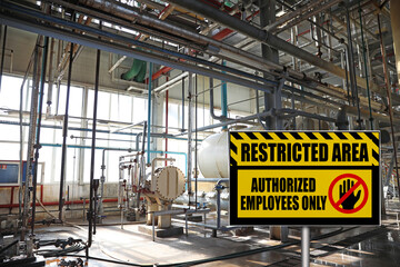 Sign with text Restricted Area Authorized Employees Only near different equipment indoors - obrazy, fototapety, plakaty