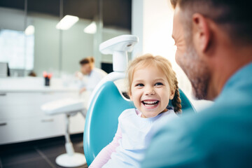 Happy little patient in dental chair waiting to be checked by a dentist. Healthy white teeth and perfect smile, healthcare.