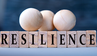 RESILIENCE - word on wooden blocks on dark blue background