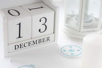 White block calendar present date 13 and month December, website events.  Winter decoration...