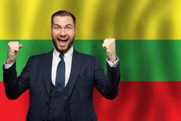 Lithuanian happy businessman on the background of flag of Lithuania Business, education, degree and...