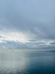 Fototapeta premium Dark clouds reflection at the sea surface, evening sea horizon