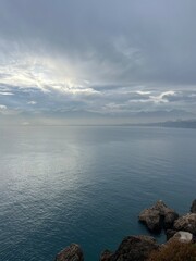 Dark clouds reflection at the sea surface, evening sea horizon