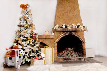 Christmas background, decorated Christmas tree with toys and glass balls near a stone fireplace with decorative Christmas tree garland and burning fire,warm fleecy carpet.Christmas home interior decor