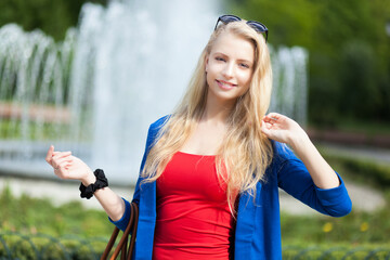 Smiling young woman enjoying sunny day in the park